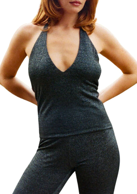 Person wearing a black lurex halter  tank top and leggings on a white background